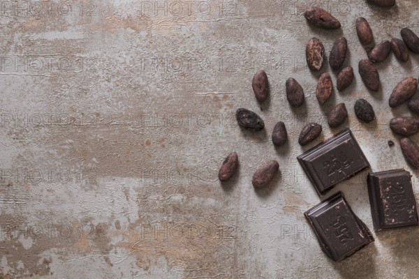 Chocolate pieces with raw cocoa beans rustic background. Resolution and high quality beautiful photo