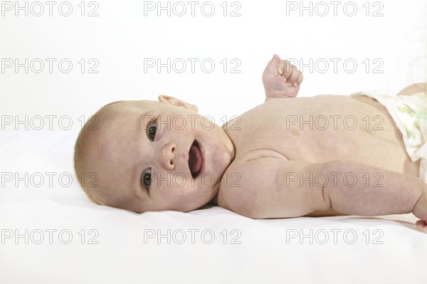 SMILING BOY AGAINST WHITE BACKGROUND