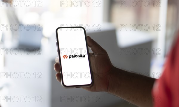 In this photo illustration Palo Alto Networks logo of an American cybersecurity company is seen on a mobile phone and a computer screen