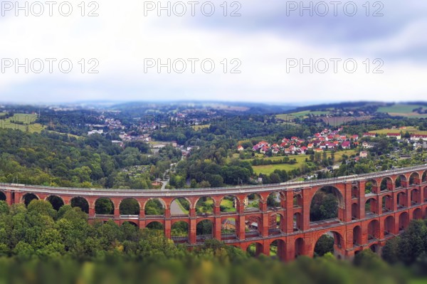 Aerial view of the Göltzsch Valley Bridge, an impressive brick viaduct that spans majestically over the Göltzsch valley. The bridge consists of several arches and is the largest brick bridge in the world. Mylau, Reichenbach, Netzschkau, Saxony, Germany