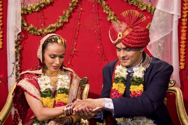 Indian bride and bridegroom holding hand performing vidhi in marriage ceremony MR Bridegroom#729E, NO MR Bride