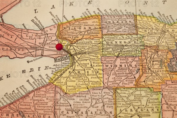 Buffalo and part of New York state on vintage 1920s map with a red pushpin, selective focus (printed in 1926 - copyrights expired)