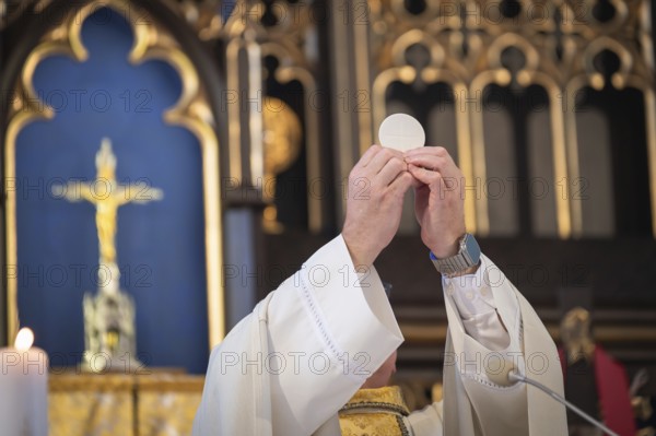 Host held aloft by the catholic priest in Poland