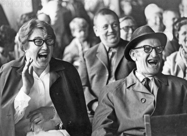 Audience in the 1960s. They are all laughing at something or someone on the stage. Sweden 1960s