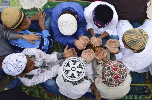 Young Muslim boys offer prayer as they celebrate Eid al-Adha or festival of sacrifice, at the Bilal Mosque in Mumbai, India