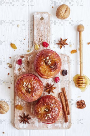 Red baked apples with cinnamon, walnuts and honey. Autumn or winter dessert. Top view