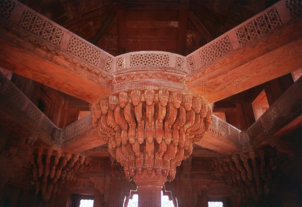 The Diwan-i-Khas, or Hall of Private Audience, is a plain square building with four chhatris on the roof. It is famous for its central pillar, which has a square base and an octagonal shaft, both carved with bands of geometric and floral designs, further its thirty-six serpentine brackets support a circular platform for the Mughal emperor Akbar, which is connected to each corner of the building on the first floor, by four stone walkways. It is here that Akbar had representatives of different religions discuss their faiths and gave private audience.<br/><br/> Fatehpur Sikri (the City of Victory) was built during the second half of the 16th century by the Emperor Akbar (r. 1556-1605). It was the capital of the Mughal Empire for 10 years