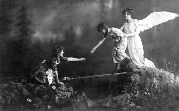 Guardian angel angel, 1930s, Angel helping a child while a woman watches from a rock, historical photo