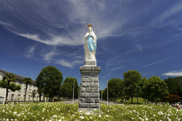 Statue of the Crowned Madonna of Our Lady in Lourdes on Rosary Square in the Marian pilgrimage town of Lourdes, Pyrenees, France