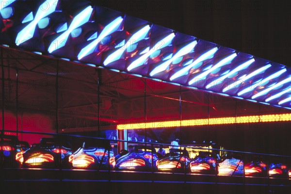 Illuminated bumper cars at night, New Jersey, USA