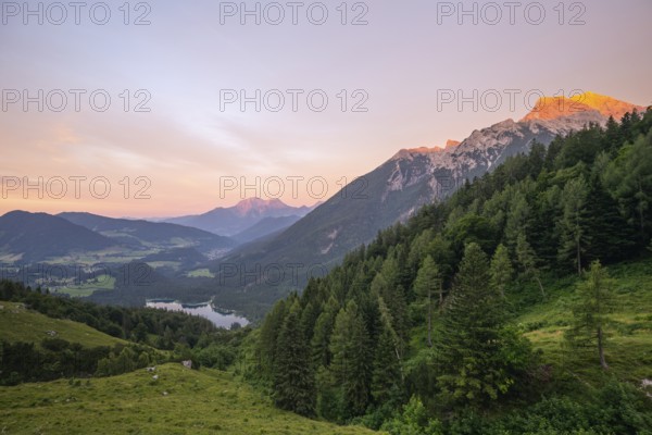 Magical sunset with alpenglow at the Halsalm above Hintersee with views of Hoher Göll and Hochkalter