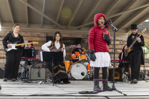 Girl sings with band at the reception for King Harald at the end of coal mining, Longyearbyen, Spitsbergen