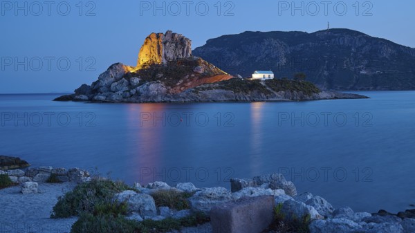 Impressive shining rock on an island at dusk with calm sea, Agios Stefanos Beach, Agios Stefanos Basilica, Chapel Agios Nikolaos, Kastri Island, Kos, Dodecanese, Greek Islands, Greece