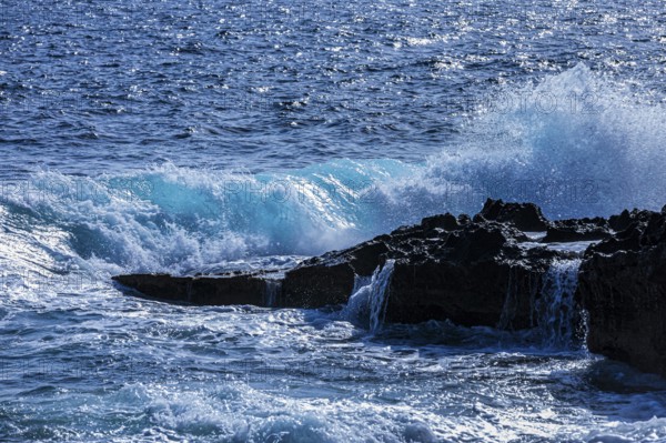 Rugged rocky coastline and foaming spray, on Stecci beach, near Capoliveri, Elba Island, Tuscan Archipelago National Park, Tuscany, Italy