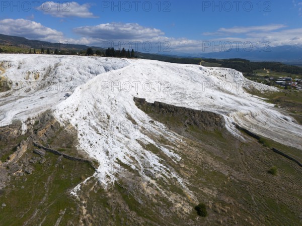 White limestone hills in a natural setting under a blue sky with clouds, aerial view, sinter terraces, limestone sinter terraces, travertine terraces, Pamukkale, Denizli, UNESCO World Heritage Site, Anatolia, Turkey