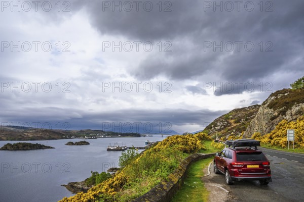 Off road 4x4 car with roof tent over Skye Bridge over Loch Alsh, Kyle of Lochalsh, Isle of Skye, Scotland, England, United Kingdom