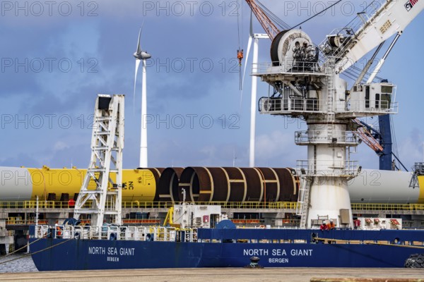 The seaport of Eemshaven, Julianahaven Basin, where the foundation structures, monopiles, for offshore wind farms are stored, which then support the actual wind turbines, the components are transported to the wind farms in the North Sea on large workboats and anchored to the seabed, where the wind turbines are then built, Eemshaven, Netherlands