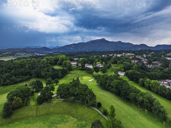 Sunset and storm clouds over Pyrenees and Saint-Jean-de-Luz from a drone, Nouvelle-Aquitaine, Pyrenees-Atlantiques, France