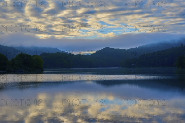 Morning sky with clouds reflected in calm lake, summer, Rursee, Obersee, Rurberg, Simmerath, Eifel National Park, North Rhine-Westphalia, Germany