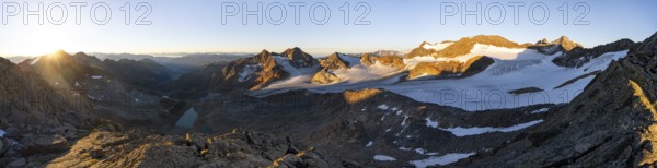 Picturesque high mountain landscape at sunrise with alpenglow, blue glacial lakes, glaciers and rocky mountain peaks in the morning light, view at Becher of mountain peaks Königshofspitz and Sonklarspitze and Schwarzwandspitz with glacier Übeltalferner, Stubai Alps, South Tyrol, Italy