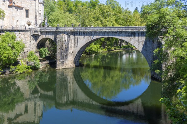 Historic bridge reflected in water of River Tamega, Amarante, Tâmega e Sousa, Portugal