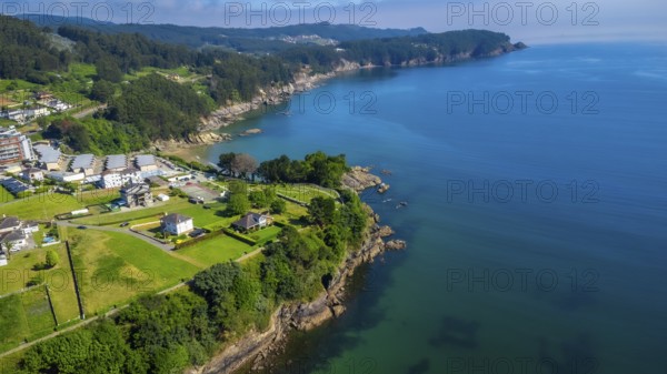 Breathtaking aerial view of covas beach meeting the cantabrian sea, showcasing the stunning coastline of viveiro, galicia, spain