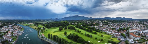 Panorama of Sunset and storm clouds over Pyrenees and Saint-Jean-de-Luz from a drone, Nouvelle-Aquitaine, Pyrenees-Atlantiques, France