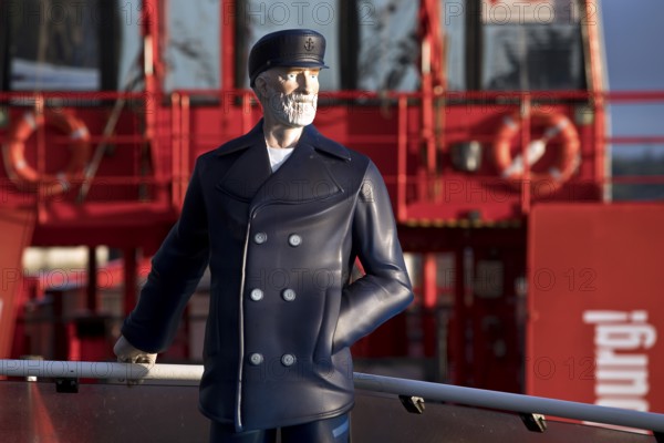 3-D figure of the captain permanently installed on the bow of the harbour ferry of line 62 in front of the ferry St. Pauli, Finkenwerder, Hamburg, Germany