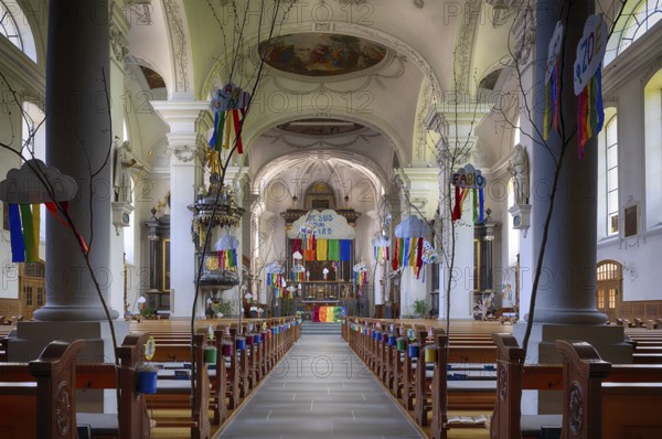 Interior view of nave, choir, altar, Peter and Paul parish church, decorated for First Communion, pillar hall church, Willisau, Canton Lucerne, Switzerland