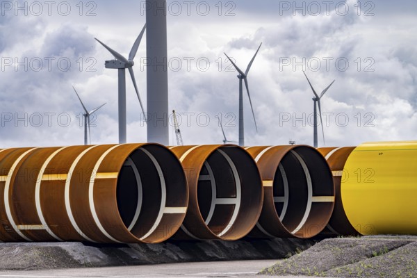 The seaport of Eemshaven, Julianahaven Basin, where the foundation structures, monopiles, for offshore wind farms are stored, which then support the actual wind turbines, the components are transported to the wind farms in the North Sea on large workboats and anchored to the seabed, where the wind turbines are then built, Eemshaven, Netherlands