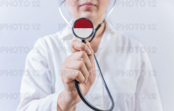 Female doctor holding stethoscope with Monaco flag. National health system of Monaco