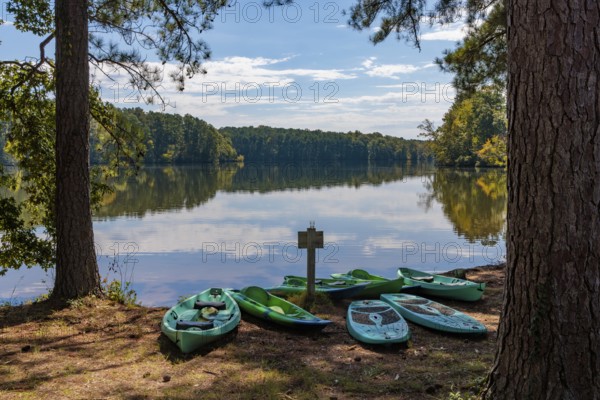 Plastic rental kayaks, canoes and paddleboards on the shore of Pin Oak Lake at The Lodge hotel in Natchez Trace State Park near Wildersville, Tennessee