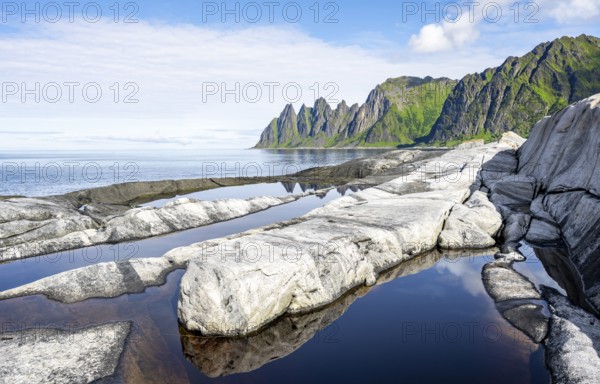 Reflection in a tidal pool, rocky coast of Tungeneset, Devil's Teeth, Okshornan, Ersfjorden, Senja Island, Troms, Norway