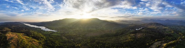 Panorama of Sunset over Mountains and Coniston Water from drone, Lake District National Park, Cumbria, England, United Kingdom