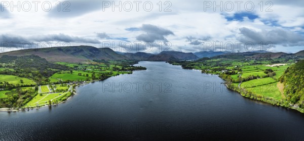 Panorama of Farms and mountains over Ullswater Lake from drone, Pooley Bridge, Lake District National Park, Cumbria, England, United Kingdom