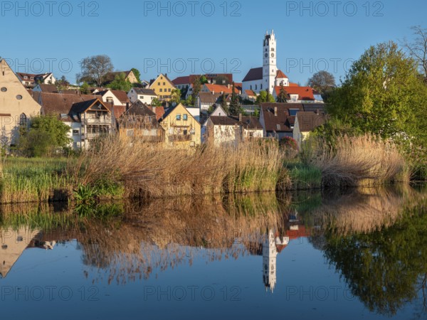 The old town centre with the Herz Jesu church is reflected in the River Wörnitz, Harburg, Donau-Ries, Swabia, Bavaria, Germany