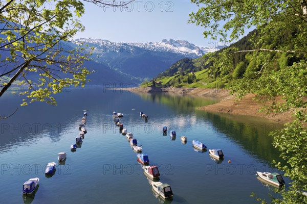 Motorboats moored at the reservoir, snow-covered Alps in the background, Lake Wägital, Canton Schwyz, Switzerland