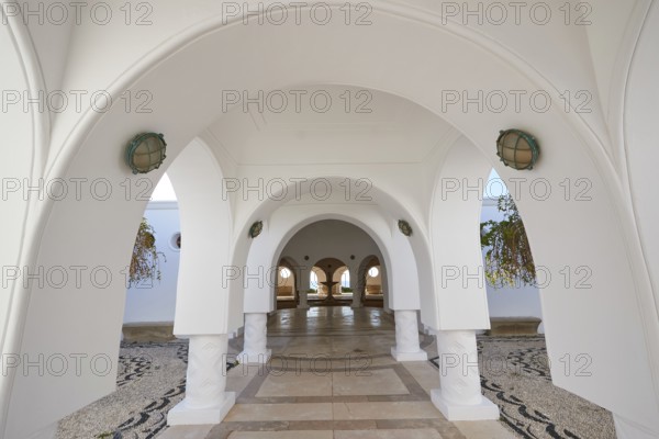 A bright corridor with white arches and decorative floor mosaic, Kalithea, Kallithea, thermal baths, spa, Rhodes, Dodecanese, Greek Islands, Greece