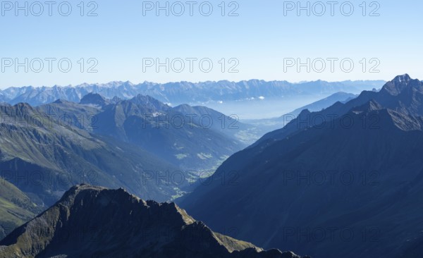 View of the Stubai Valley, mountain silhouettes, from the summit of the Wilder Freiger, Stubai Alps, South Tyrol, Italy