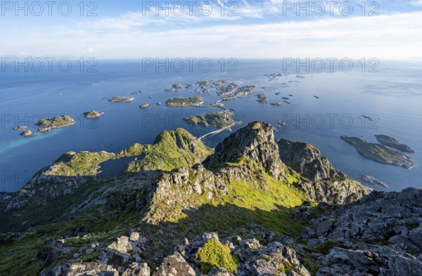 View of numerous small rocky islands with houses, at the summit of Festvågtind, view of Henningsvær, Vågan, Lofoten, Nordland, Norway