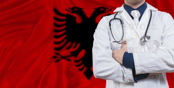 Male doctor with stethoscope on Albania flag. Doctor holding stethoscope on Albania flag