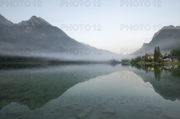 Magical sunrise with fog at Hintersee near Ramsau in Berchtesgadener Land
