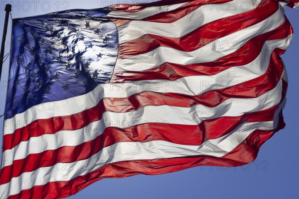 Dramatic backlit american flag waving in the wind