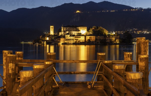 Wooden footbridge with view of Isola San Guilio, Orta San Giulio, on Lake Orta, Province of Novara, Piedmont, Lago d'Orta, Italy