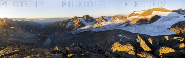 Picturesque high mountain landscape at sunrise with alpenglow, blue glacial lakes, glaciers and rocky mountain peaks in the morning light, view at Becher of mountain peaks Königshofspitz and Sonklarspitze and Schwarzwandspitz with glacier Übeltalferner, Stubai Alps, South Tyrol, Italy