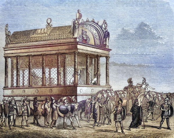 The funeral carriage with the body of Alexander the Great, coloured wood engraving, reproduction of a model from ca 1888, Historical, Ceremonial procession around an ancient, artistic building with Colosseum elements