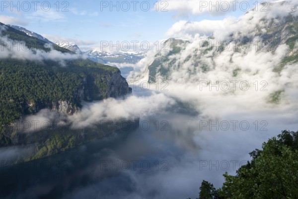 View over the Geirangerfjord, atmospheric clouds over the fjord in the morning light, Ørnesvingen viewpoint, near Geiranger, Møre og Romsdal, Norway