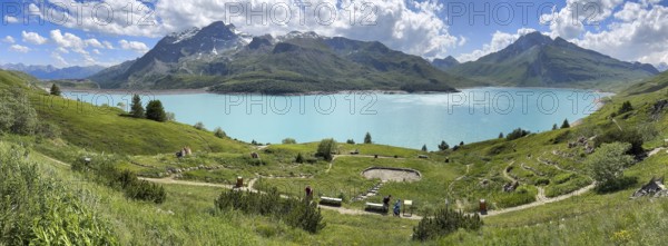 Panoramic view of Lac du Mont Cenis, in the foreground Alpine garden Jardin Alpin next to pass road to pass Alpine pass Mountain pass Col du Mont Cenis Colle del Moncenisio, Mont Cenis massif, Massif du Mont-Cenis, Graian Alps, Lanslebourg, Rhone-Alpes, France