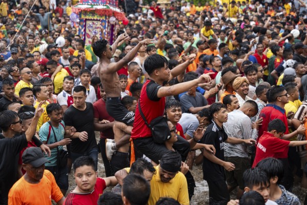JOWAI, INDIA - JULY 14: People from the Pnar community march in a circle as they celebrate an event organized to mark the Behdienkhlam festival in Jowai, India on July 14, 2025. Behdienkhlam is a vibrant annual festival celebrated by the Pnar (Jaintia) community of Meghalaya, especially in Jowai, to drive away plague and diseases and to pray for a good harvest. Observed in July after the sowing season, it features traditional rituals, offerings to ancestral spirits, and the grand procession of beautifully decorated bamboo structures called rots, which are later immersed in a sacred muddy pool known as Ka Aitnar