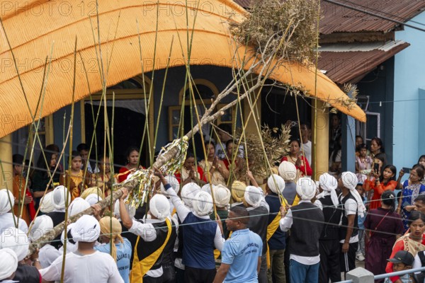People from the Pnar community perform rituals as they using a tree to celebrate an event organised to mark the Behdienkhlam festival in Jowai, India on July 14, 2025. Behdienkhlam is a vibrant annual festival celebrated by the Pnar (Jaintia) community of Meghalaya, especially in Jowai, to drive away plague and diseases and to pray for a good harvest. Observed in July after the sowing season, it features traditional rituals, offerings to ancestral spirits, and the grand procession of beautifully decorated bamboo structures called rots, which are later immersed in a sacred muddy pool known as Ka Aitnar